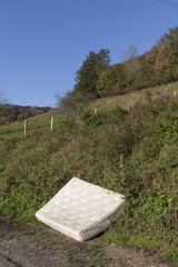 Dumped mattress fly tipped in Countryside