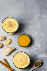 Pumpkin turmeric drink on stone background. Top view, copy space.