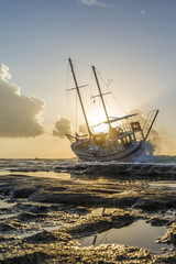 Wrecked boat abandoned stand on beach in RHodes Greece