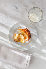 a still-life of fresh French baking, rolls with almond puree and snails with custard and raisins lying on a napkin top view.