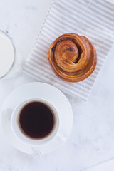 a still-life of fresh French baking , rolls with almond puree and snails with custard and raisins lying on a napkin top view.