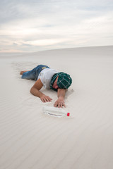 Exhausted traveler lies next to a bottle of water