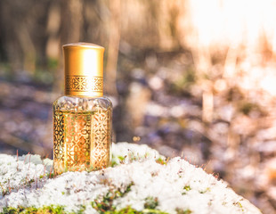 Arabic perfume on a winter background. Scented oil in mini bottles.
