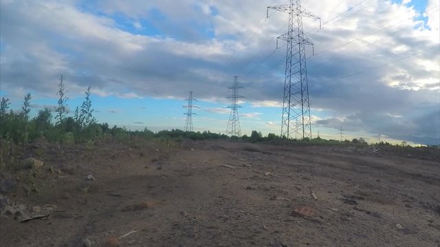 power lines on a field on a summer day timelapse