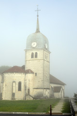Abbey church in Jura, France and cure (house of the priest).