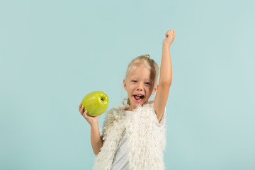 Pretty, cute girl in light clothes hold apples