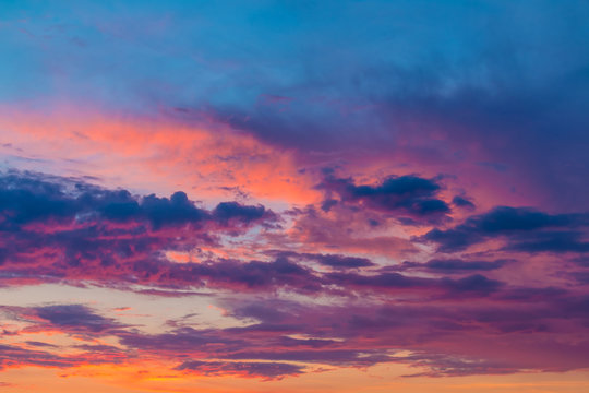 Beautiful cloudscape with colorful contrasting clouds at sunset © dr_verner