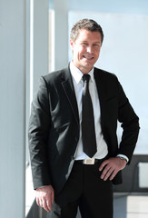 portrait of confident businessman on blurred background