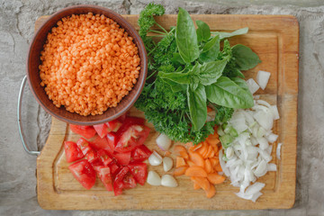 Ingredients for lentil soup. Lentils, tomatoes, onions, garlic, basil, potatoes.