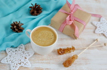 Cup of Coffee with Christmas Decorations on Wooden table, Snow Down, Toned Photo
