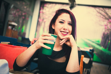 Beautiful girl drinking coffee at the coffee shop