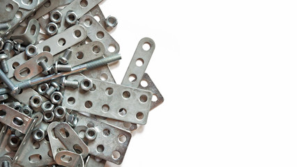 Details of silvery metal children's designer isolated on white background. Bolts, screws and nuts...