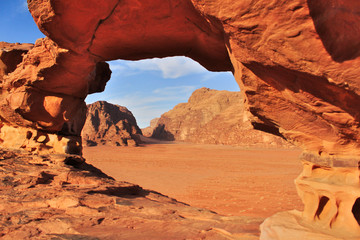 Wadi Rum red dessert in Jordan.The view of rock formations by natural rock window.