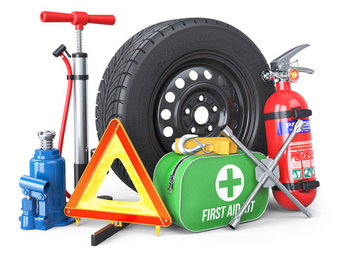 A set of automotive accessories. Spare wheel, fire extinguisher, first aid kit, emergency warning triangle, jack, tow rope, wheel wrench, pump