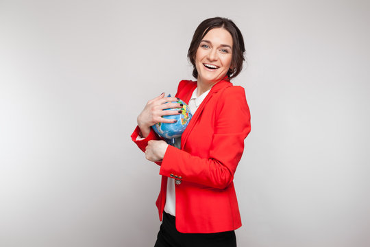 Picture of pretty woman in red blazer with earth sphere in hands