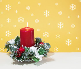 Abstract christmas background,Italy,31 Ottobre 2017,New Year's background, abstraction, greeting card, wallpaper,red candle on a candlestick with decorative fruits and spruce branches