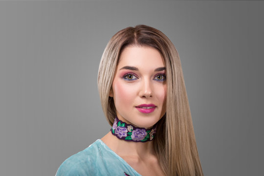 Beautiful face with brightly colors of make-up and blonde straight long hair