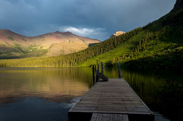 Sunset behind the pier on Lower Two Medicine lake at Glacier national park, Montana, United States