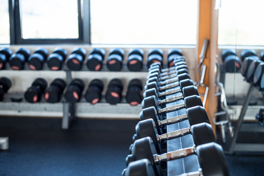 Row of dumbbells in gym