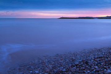 Sunset over the English Channel in the town of Sidmouth. Long exposure. Devon. UK