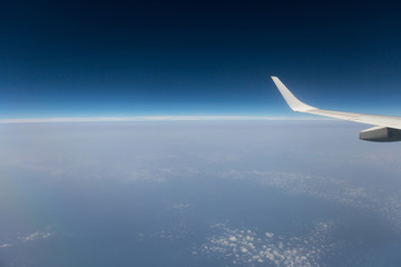 Fototapeta na wymiar view from the airplane window, cloud wing, dimensions.