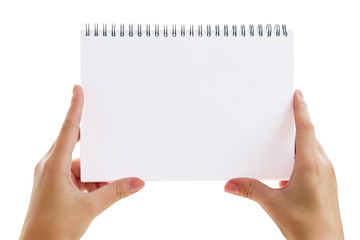 Obraz premium White blank sheet of paper in the notebook in female hands isolated on white background, mock up