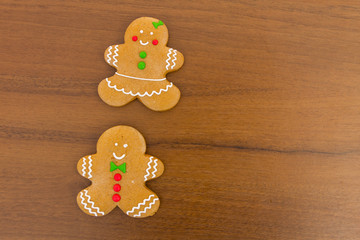 Christmas gingerbread couple cookies on wooden table