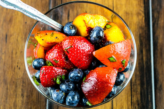 A bowl of fresh fruit with mint