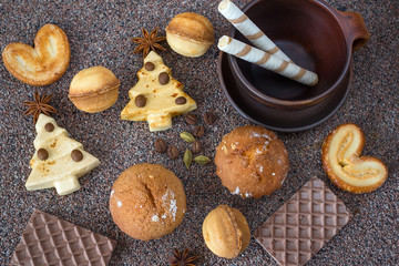  New year, Christmas treats, sweets. Ceramic Cup, cookies, striped candy, spices of anise, cardamom and coffee. Delicious homemade Christmas cookies. Over my head.