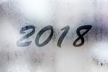 Happy New Year concept with foggy writting 2018 on the mirror