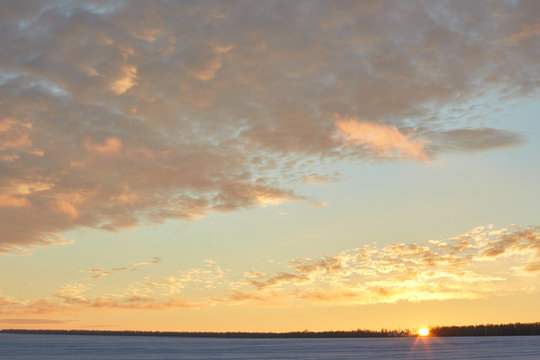 beautiful sunset in winter. Snow, frost, clouds © vadiar