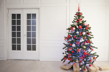 new year tree in the room with Christmas gifts