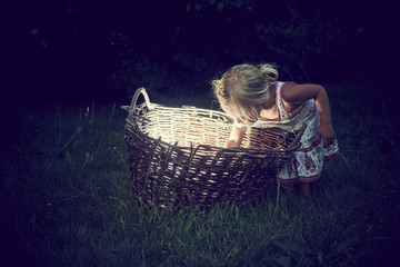 Girl found something shining in a wicker basket at night