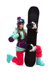 young beautiful woman in purple ski coat stand on knee and hold snowboard