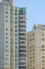 Urban background of the facades of multi-storey apartment buildings against the background of a clear sky