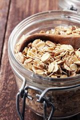 Healthy food concept with oats meal on brown rustic background.