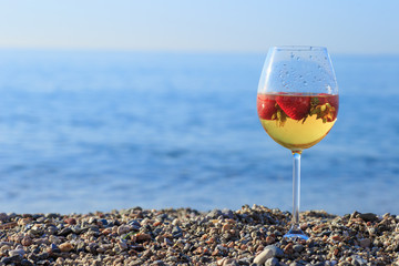 Frozen strawberry sangria cocktail at the edge of the sea.