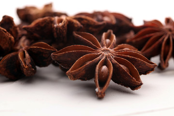 Anise star seeds on the wooden background. Aromatic ingredient in culinary