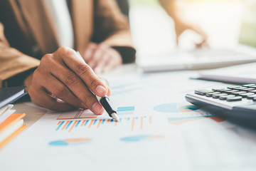 Woman with bills and calculator. Woman using calculator to calculate bills at the table in office. Calculation of costs.