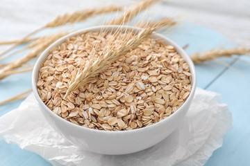 Bowl with raw oatmeal on table