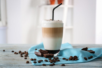 Glass with latte macchiato on blurred background