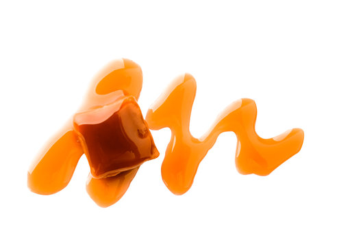 Sweet candy with caramel topping on white background