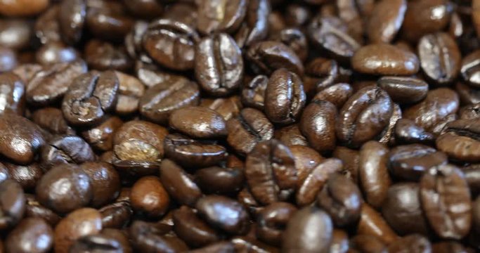 Roasted brown coffee beans, can be used as a background. 4k video.