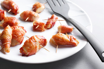Bacon wrapped chicken on plate, closeup