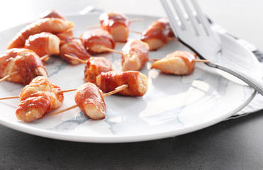 Bacon wrapped chicken on plate, closeup