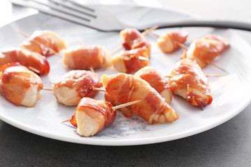 Bacon wrapped chicken on plate, closeup