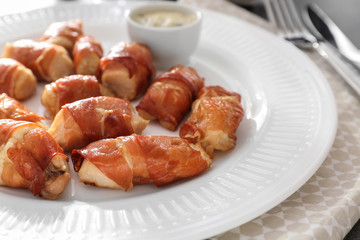 Bacon wrapped chicken on plate, closeup