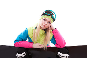 beauty young woman in ski suit and ski glasses sit with sbowboard