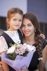 Young mother escorts her daughter to the first class