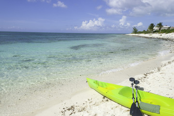 Kayak with paddles on the white sand beach at the Caribbean sea. Paradise. 